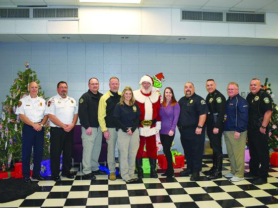 From left: Gilmer Fire Chief Daniel Kauffman, Gilmer EMA Director Keith Kucera, Ellijay Fire Chief Sam West, Sheriff Stacy Nicholson, GBI Special Agent Renea Green, Santa, Gilmer Charter Schools Superintendent Dr. Shanna Downs, East Ellijay Police Lt. Shane Bowman, Ellijay Police Chief Ed Lacey, Walmart manager Tom Horton and Ellijay Police Capt. Ray Grace.