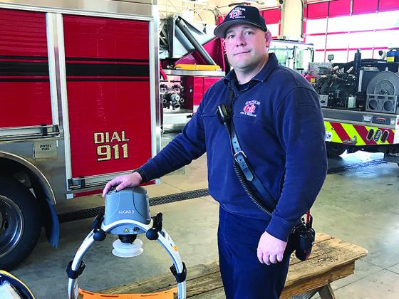 Gilmer Fire and Rescue Battalion Chief Eric Irish is shown with one of the two LUCAS chest compression devices recently acquired by the county public safety agency. 