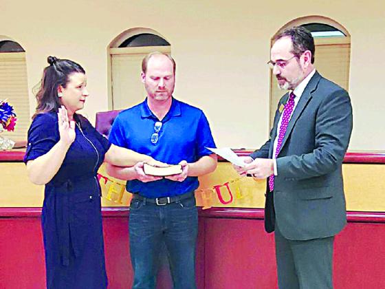 Tracey Teague, pictured with husband, Bobby and Probate Judge Scott Chastain, during her swearing-in ceremony.