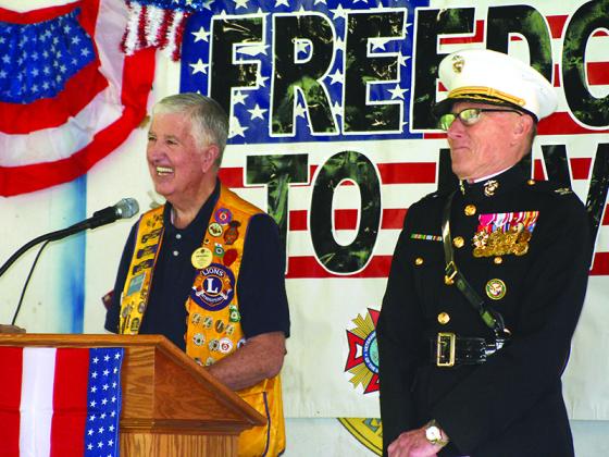 Lions Club President Sam Burrell welcomes attendees to the event, which was held in a new location this year.