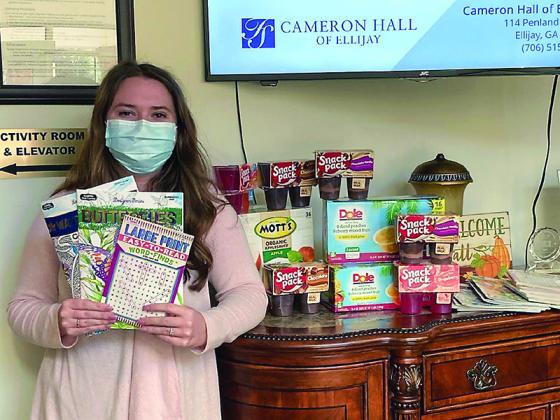 Macy Dotson, of Cameron Hall Assisted Living, is pictured with some of the items that have been donated for a holiday gift drive for local homebound senior citizens. 