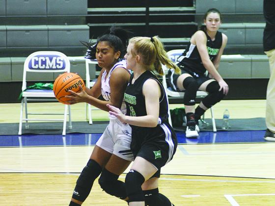Lady Cat Carly Becerra drives to the basket in the eighth-grade game.