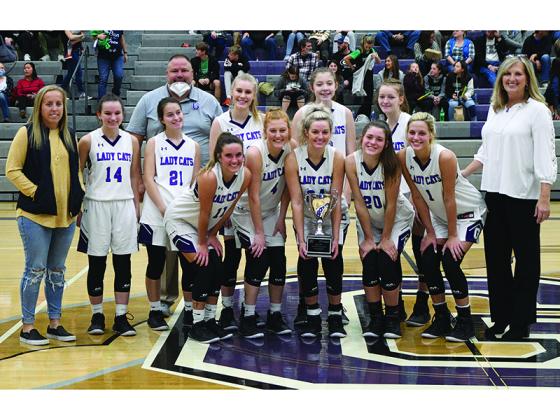 Gilmer High School Lady Cats and coaches celebrate their tip-off tournament championship last week.