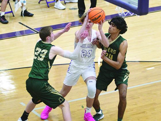 Gilmer High School senior Bryson Sisson drives the baseline between a pair of Adairsville Tigers last Saturday.