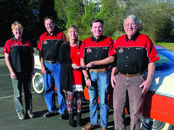 Linda Ewing,center, presents a donation check to Apple Country Auto Club members Judith Burgess, Jim Logan, Andrew Miller and Ronnie Prater. The funds will be donated to several local nonprofits and organizations, which is a year-end tradition for the car club. 