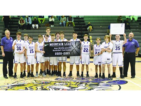 Clear Creek eighth-grade basketball players and coaches celebrate the Bobcats’ undefeated league championship last Friday.