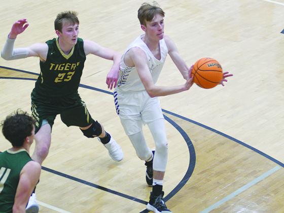 Bobcat senior Brady Sanford passes to the perimeter and scored 13 points against Walker last Wednesday .