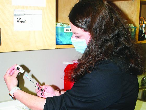 Nurse Jennifer Vick draws a dose of COVID-19 vaccine during the Gilmer County Health Department’s recent vaccination of local health care workers.