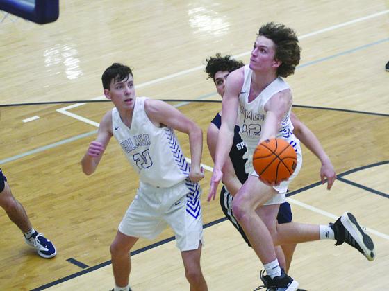 Gilmer senior Braden Jenkins eyes the basket as teammate Lewis Mulkey (20) gets in position to rebound. Jenkins scored 19 points, and Mulkey pulled down 10 rebounds in the Bobcats’ win over West Hall last Tuesday.