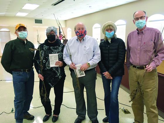 Above, Keep Gilmer Beautiful members Jim Harris, left, and Karen Vitelli, fourth from left, give red oak and dogwood seedlings to county commissioners Karleen Ferguson, Charlie Paris and Hubert Parker. 