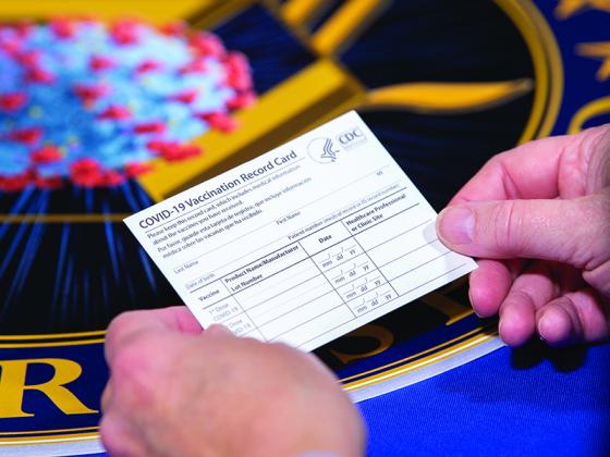 Vaccination record cards given after one’s first COVID-19 vaccine, and updated following the second dose, could prove useful when traveling, some are saying.