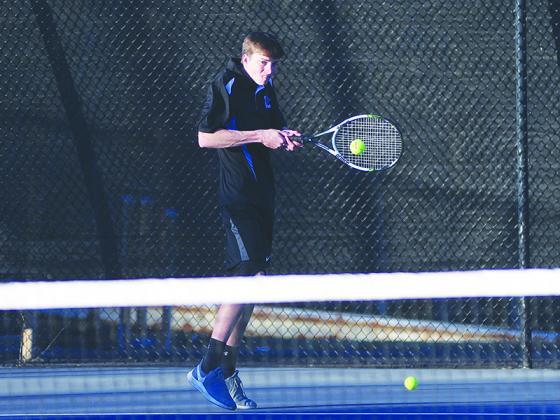 Gilmer senior tennis player Issac Bradshaw (above) helped earn a doubles victory versus White County last Tuesday and Beth Burnette (below) did the same for the Lady Cats on the No. 2 singles court.