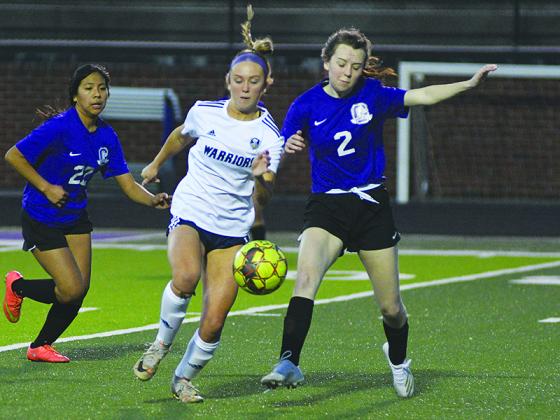 Gilmer Lady Cat defender Cadence Smith (2) jostles to get the ball away from an opposing forward.
