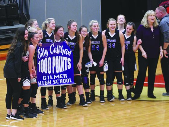 Gilmer players celebrate Elly Callihan surpassing 1,000 career points.