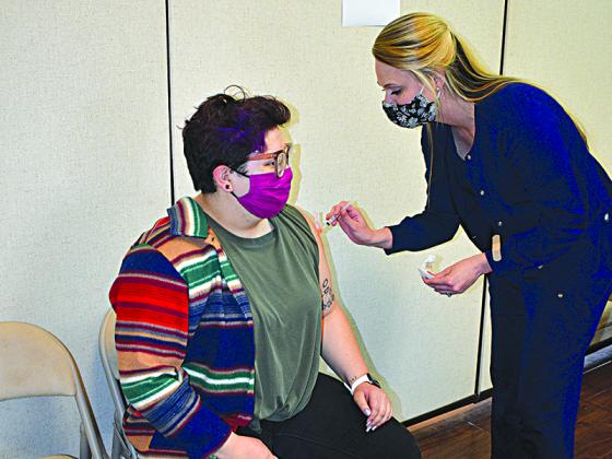 Gilmer High School algebra teacher Reyna Hernandez receives her COVID-19 vaccine by health department employee Courtney Kephart, Tuesday, March 9.