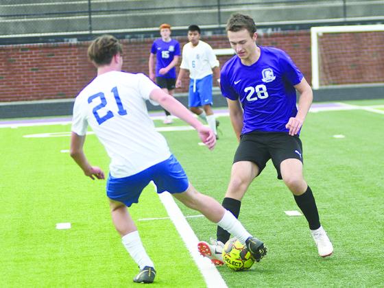 Gilmer High senior forward Tyler Jack (28) tries to win possession from a defender for the Bobcats.