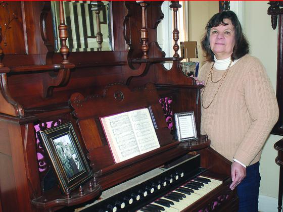 Gilmer Historical Society President Leslie Thomas is shown with a vintage parlor pump organ recently donated to the historical society’s Tabor House Museum.