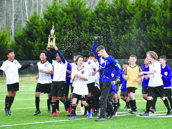 The Clear Creek Middle School Bobcats celebrate their Mountain League soccer championship last Monday.
