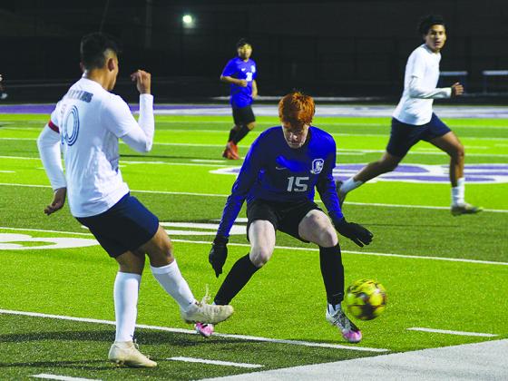 Gilmer’s Camden Lyles (15) closes down on the ball and forces a pass against West Hall last Friday. He scored a goal for the Bobcats in the first half.