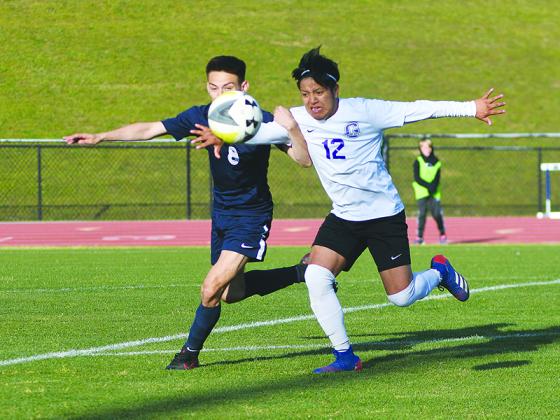 Bobcat captain Domingo Loarca (12) shields a Coahulla Creek Colt from the ball during last Wednesday’s state tournament match.