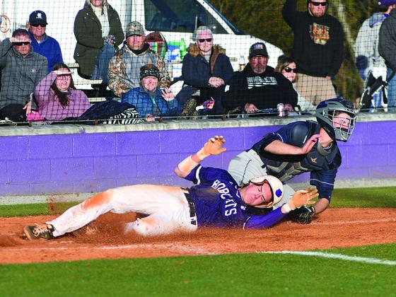 Gilmer’s Spencer Merritt collides with White County’s catcher last Friday as he attempts to steal home on a wild pitch.
