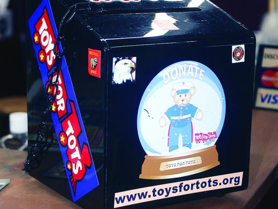 A chained-down Toys for Tots donation box like this one was recently taken from downtown shop TJ and Company Antiques. The pictured box sits on the store’s front counter, while the tampered-with box was in its rest room.  