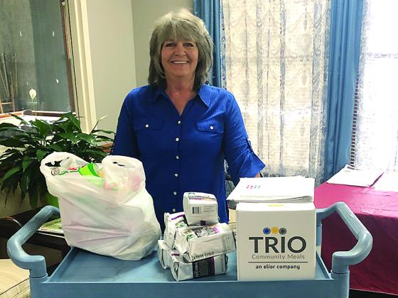Gilmer Senior Center employees and Meals on Wheels drivers Sue Reece, above, and Janice Melvin, below, are shown with food from the Gilmer Community Food Pantry that’s been bagged to distribute to those enrolled in the center’s meal programs.