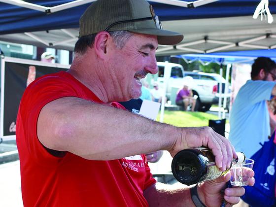 Bobby McNeill, of Chateau Meichtry, pours cups for customers at the 2019 Taste of Ellijay held along Broad Street.