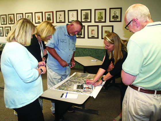 Landscape architect Madie Fischetti, fourth from left, reviews an overhead map of downtown Ellijay with city councilmembers Sandy Ott, Katie Lancey, Tom Crawford and Mayor Al Hoyle.