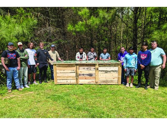 Above, students in a construction class at Gilmer High School stand with their teacher, Dennis Wilson, beside a new compost bin for the Gilmer County Library’s educational garden that was built as a class project. From left: Harley Baughman, Zachary Bobak, Anthony Whisnant, Thomas Blasingame, Nicholas Chadwick, Juan Lopez, Carlos Jacinto-Bautista, Pascual Perez, Gage Lowman, Raymondo Figueroa, Arturo Gonzalez-Santos and Wilson.