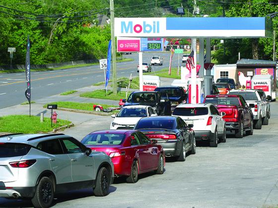 A line at the pumps forms last Tuesday evening at Holt’s Mini Mart on Industrial Boulevard.