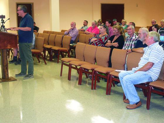 Lloyd Clark, at podium, speaks to the Gilmer County Board of Commissioners at a work session also attended by several local residents who either support or oppose a farm winery planned by Clark.