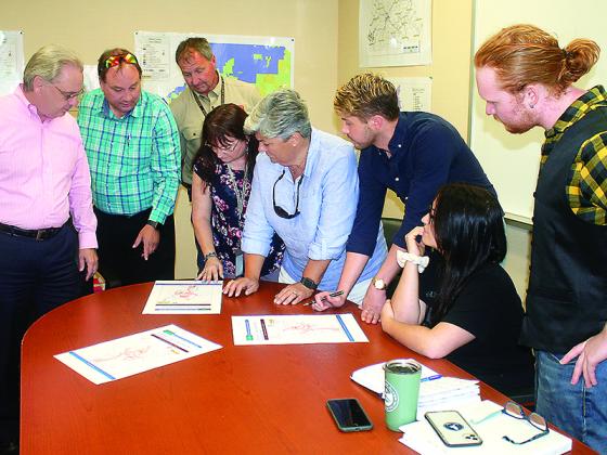 Members of an affordable housing action group join Water Authority Director Gary McVey in looking at a map of the county’s existing water and sewer infrastructure. Pictured, from left: Gilmer Joint Development Authority Director Kent Sanford, McVey, Planning Commission member Jim DuPont, Planning and Zoning Director Karen Henson, Post Two Commissioner Karleen Ferguson, Edward Sanford, Jadie Lee and Jonathon Miller.