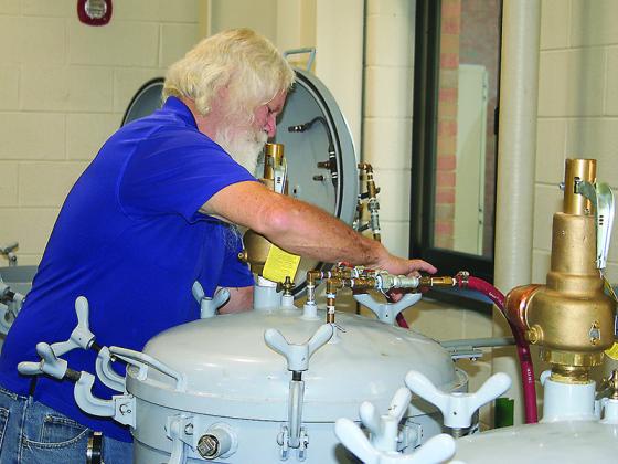 Supervisor Larry Young checks one of the industrial pressure cookers at the Gilmer County Cannery.