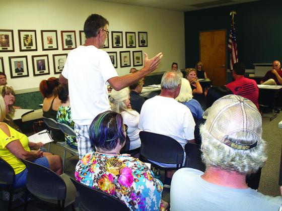 Calvin Wilson, standing, talks with Mayor Al Hoyle and Ellijay City Councilmembers about a proposed short-term rental ordinance during a June 21 council workshop.