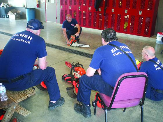Gilmer Fire and Rescue firefighter/EMT Roger Jarrard leads a chain saw safety training class for the department’s employees. 