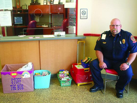 Deputy Fire Chief Mark Chastain is pictured with a Stuff the Bus drop-off box and donations at Gilmer County Fire and Rescue Station 1 on Howard Simmons Road.