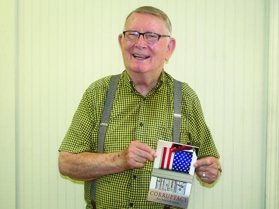 Don VanLandingham is pictured with a copy of his novel, Corruptacy.