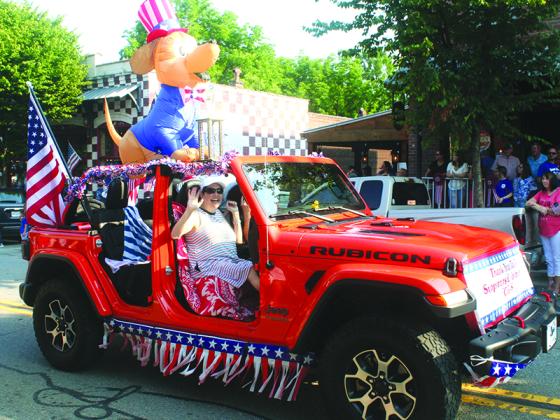 First-place trophy winning float in the Ellijay Fourth of July Parade were, in the noncommercial category, Friends of the Gilmer Animal Shelter in their patriotically decorated Jeep.