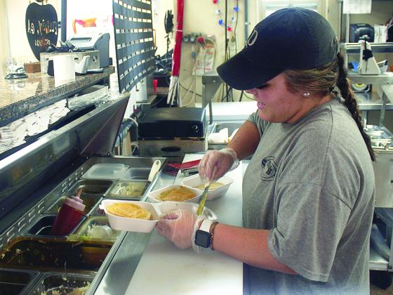 Jacie Rogers fixes an order at Mr. P’s Take Out Food. The longtime North Main Street takeout spot is among local restaurants that have had to change their operating hours due to staffing shortages. 