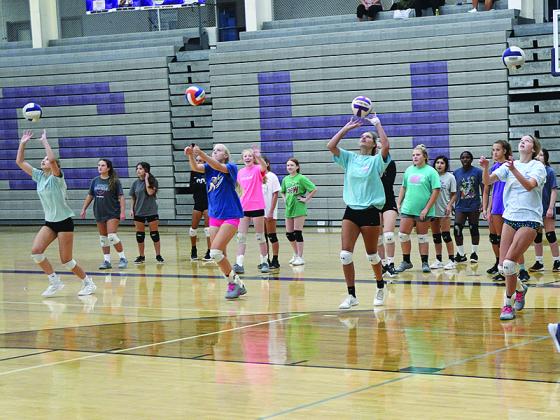 Gilmer High School volleyball players use a setting drill to warm up last Friday at their annual All-American camp. The three-day event concluded a camp schedule that started last Monday in Gainesville.