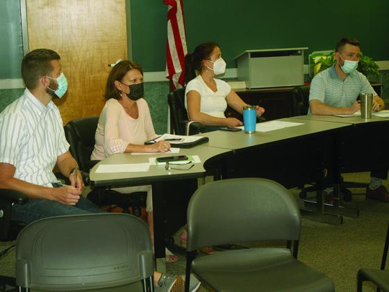 Ellijay DDA members Josh Moyers, Melinda Hadden, Sarah Burnette and Reece Sanford discuss an upcoming town hall meeting that will address a temporary no parking setup on the downtown roundabout.
