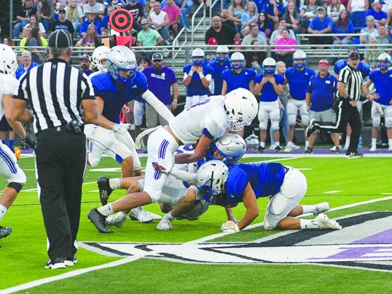 Gilmer quarterback Seth Darling lowers his shoulder to gain some extra yardage at the end of a run versus Fannin County last Friday.