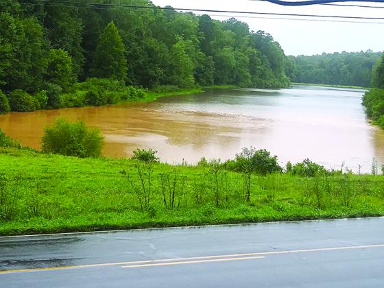 This photo taken from Old Highway 5 South during heavy rain last week shows red mud from construction of the roundabout discoloring Lake Paul. 