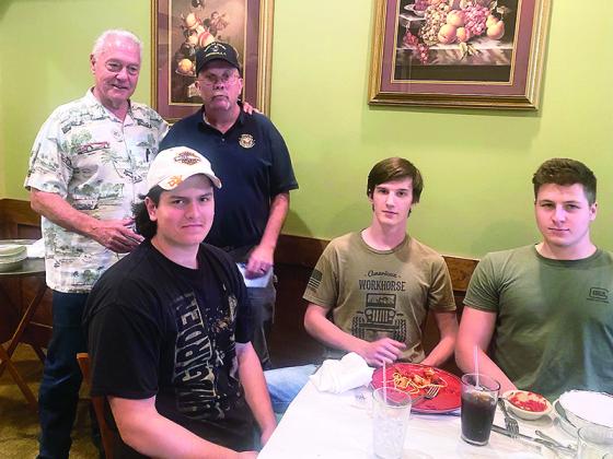 During a recent dinner meeting at Charlie’s Restaurant, Gary Johnson, Ellijay Mountain Cruisers Car Club manager, back left, presents $900 in gift cards to Gilmer High School auto tech teacher Ken Martin, back right. Also pictured, from front left, are auto tech students Dominick McAuliffe, Jonah Sutton and Kenneth Withrow. 