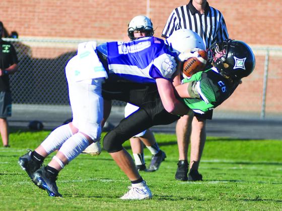 Clear Creek seventh grader Douglas Callihan meets a Pickens receiver across the middle last Thursday. Callihan scored two rushing touchdowns, had a touchdown reception and added a 70-yard kickoff return for six more points.