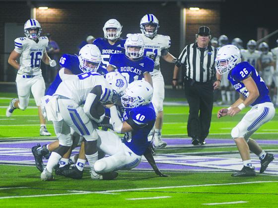 Gilmer High School’s Hunter Brown (40) and Tony Olea (66) tackle Cherokee Bluff’s Jayquan Smith during last Friday’s home game.