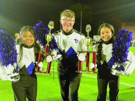 Grand champion drum majors, from left, Ashlee Lopez, Dakota Brown and Alba Monraga-Telles are shown with trophies they earned at the competition.