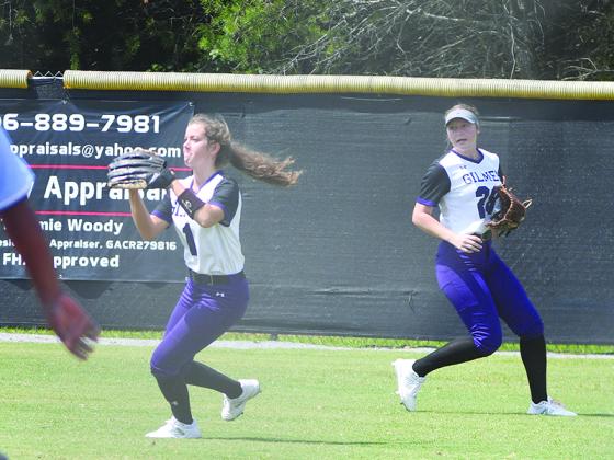 Senior Lady Cat Tori Hughes (1) returns the ball to the infield as she is backed up by teammate Jacie Bennett.