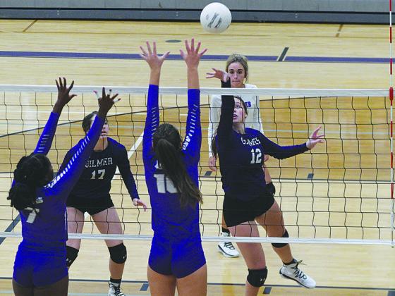 Gilmer High School senior hitter Kadie Weaver (12) tips the ball over the net last Tuesday against the Cherokee Bluff Bears.